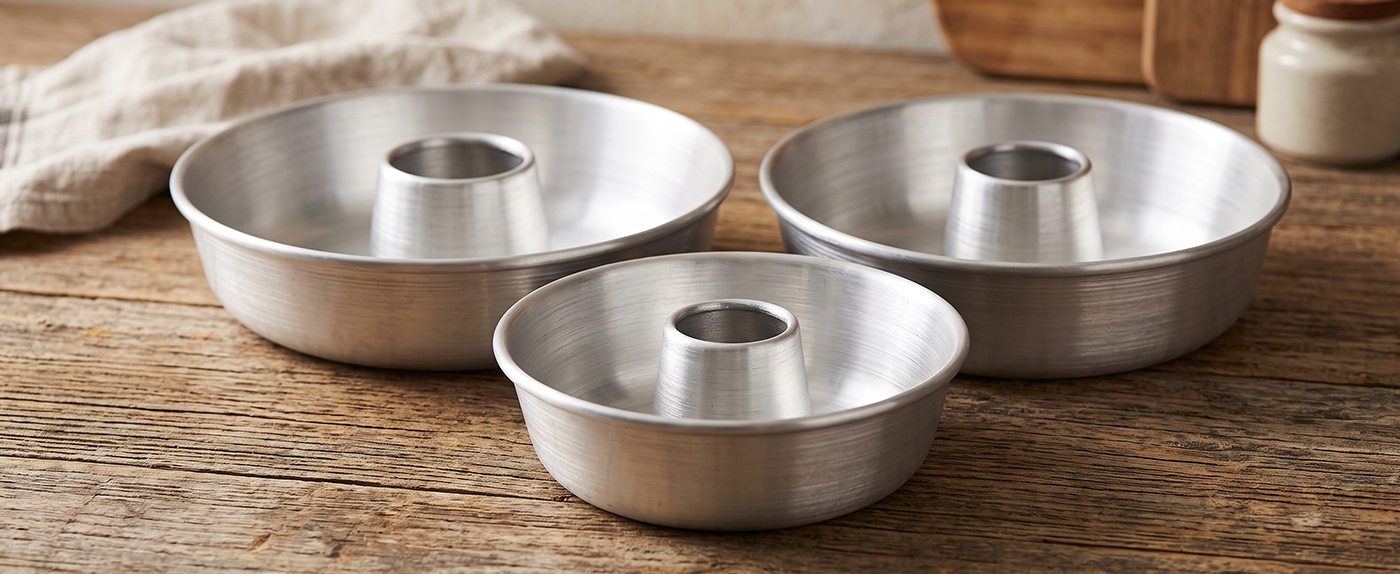 The three Globe Rocket ring cake pan sizes arranged together on a kitchen counter
