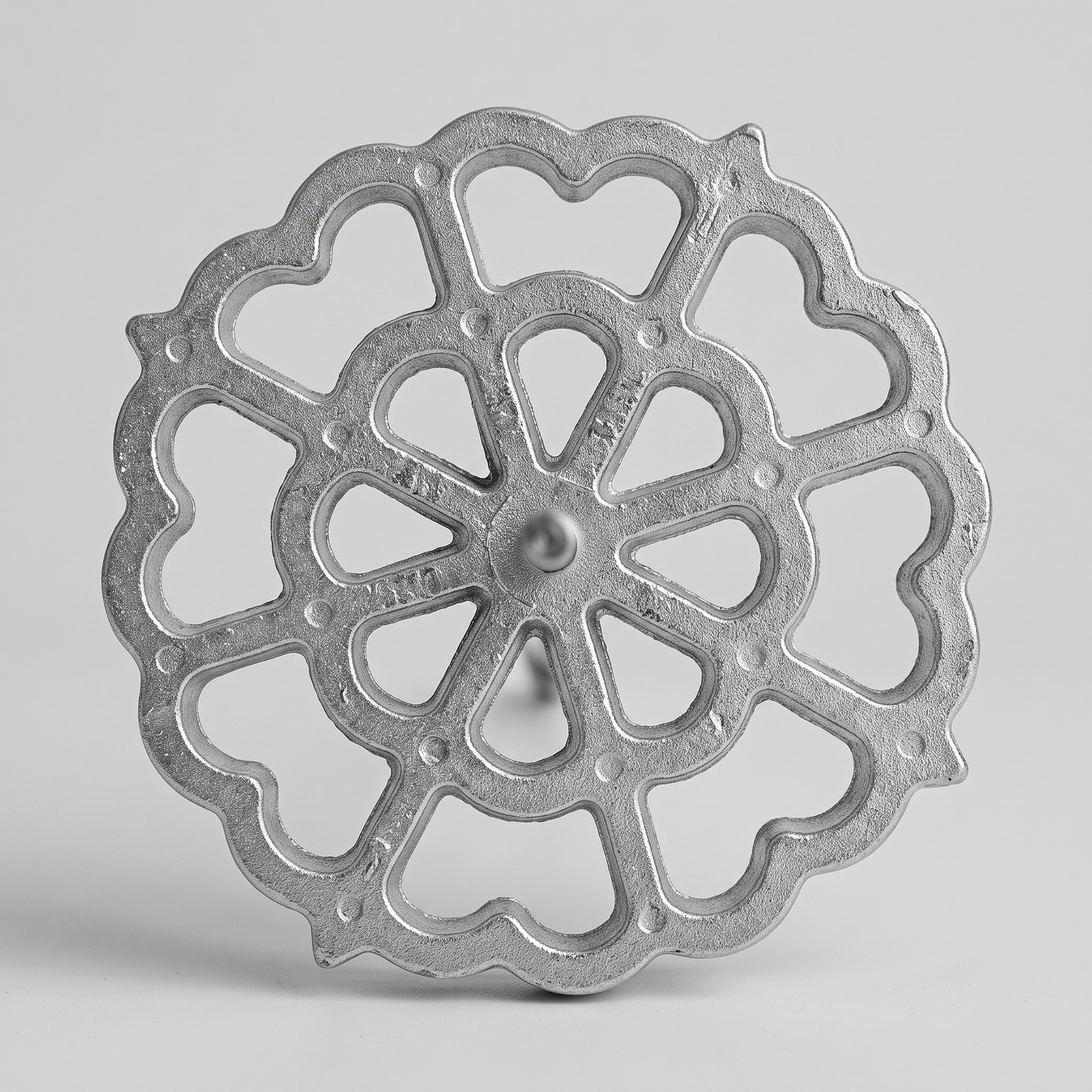 Macro close-up of the cast aluminum flower-shaped bunuelos mold head