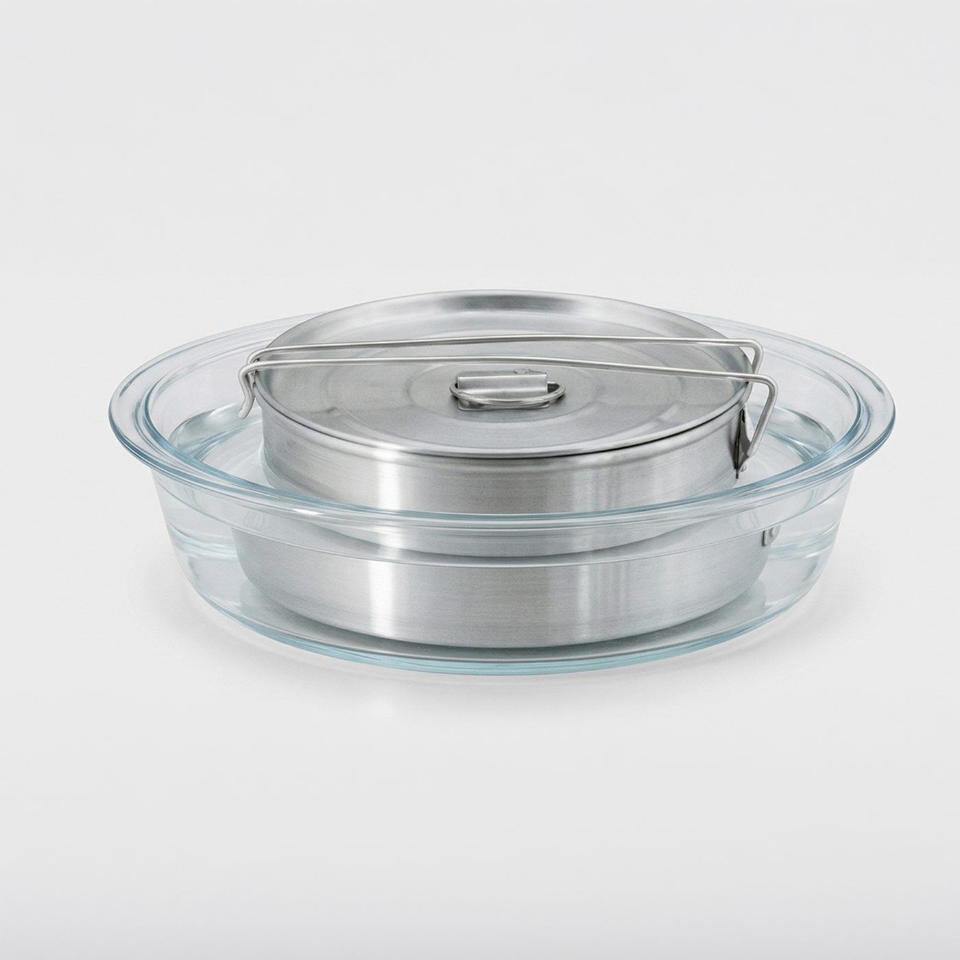 Flan mold placed inside a larger glass water bath dish before baking