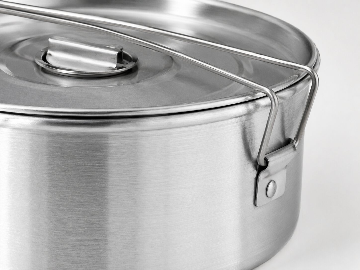 Close-up of the Globe Rocket flan mold's construction, showing the aluminum body and galvanized steel lid clasp
