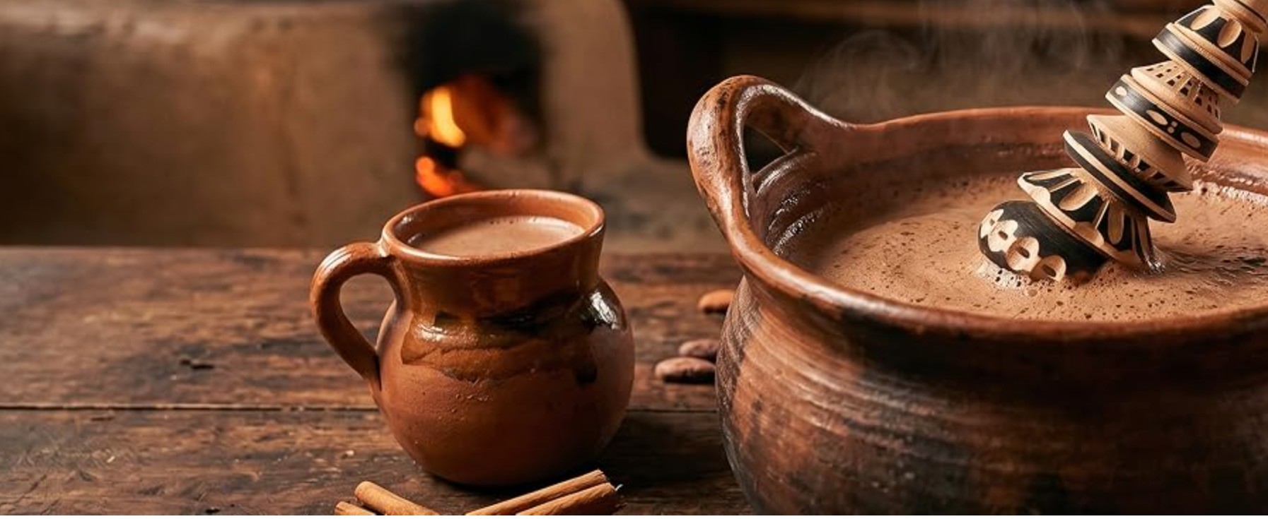 A handcrafted Globe Rocket molinillo frothing hot chocolate in a traditional clay pot