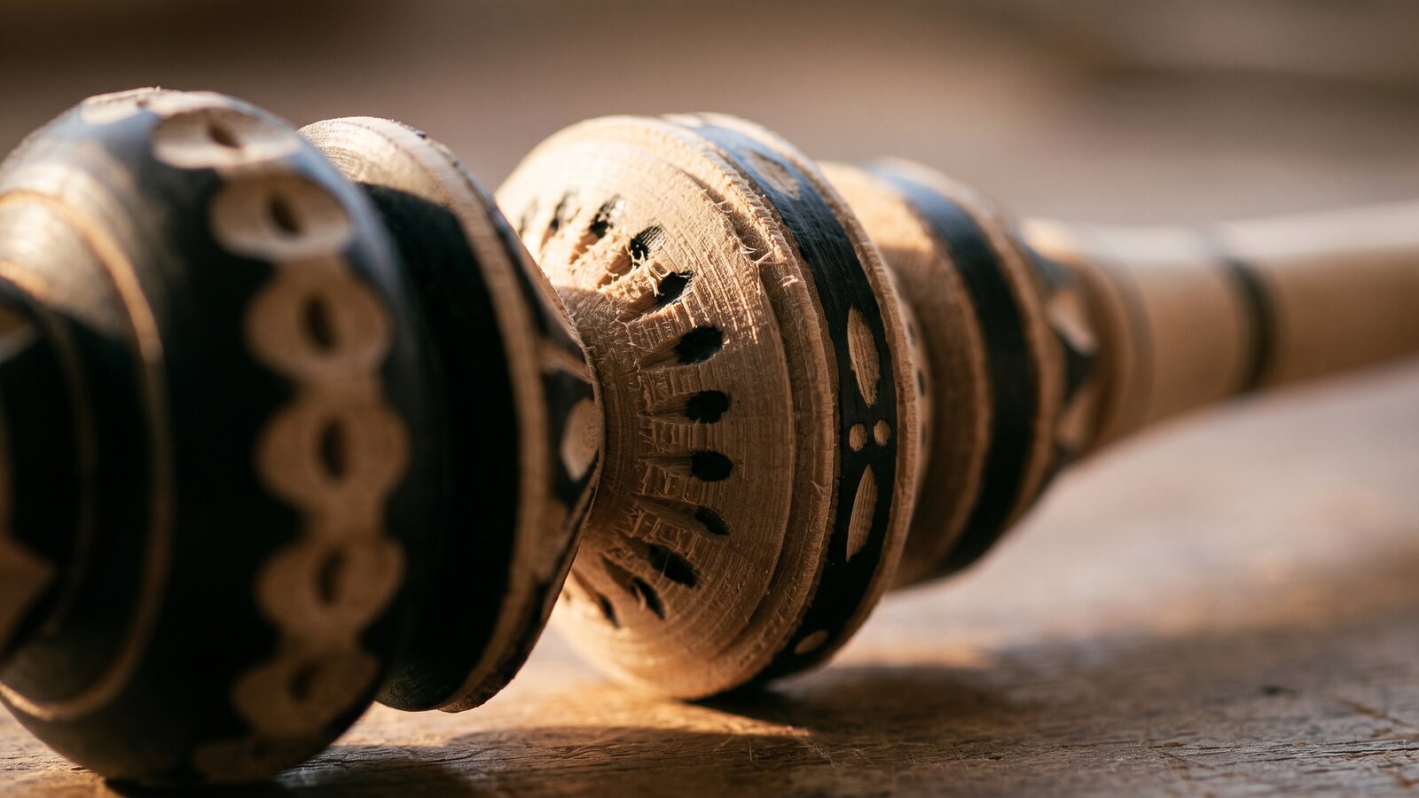 Close-up of a molinillo's carved wooden ring, still attached to the shaft, showing the undercut groove that lets it spin freely