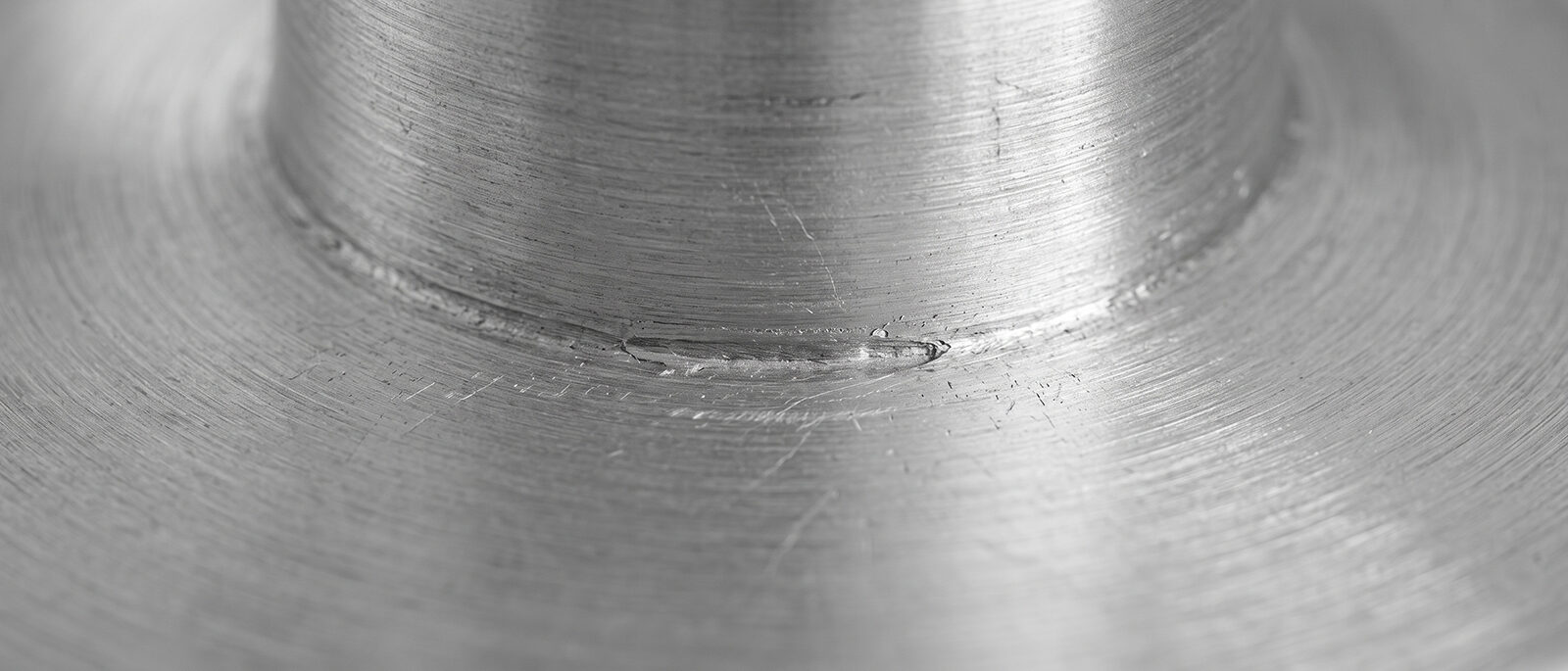 Close-up of the aluminum ring cake pan's welded seam and brushed metal construction