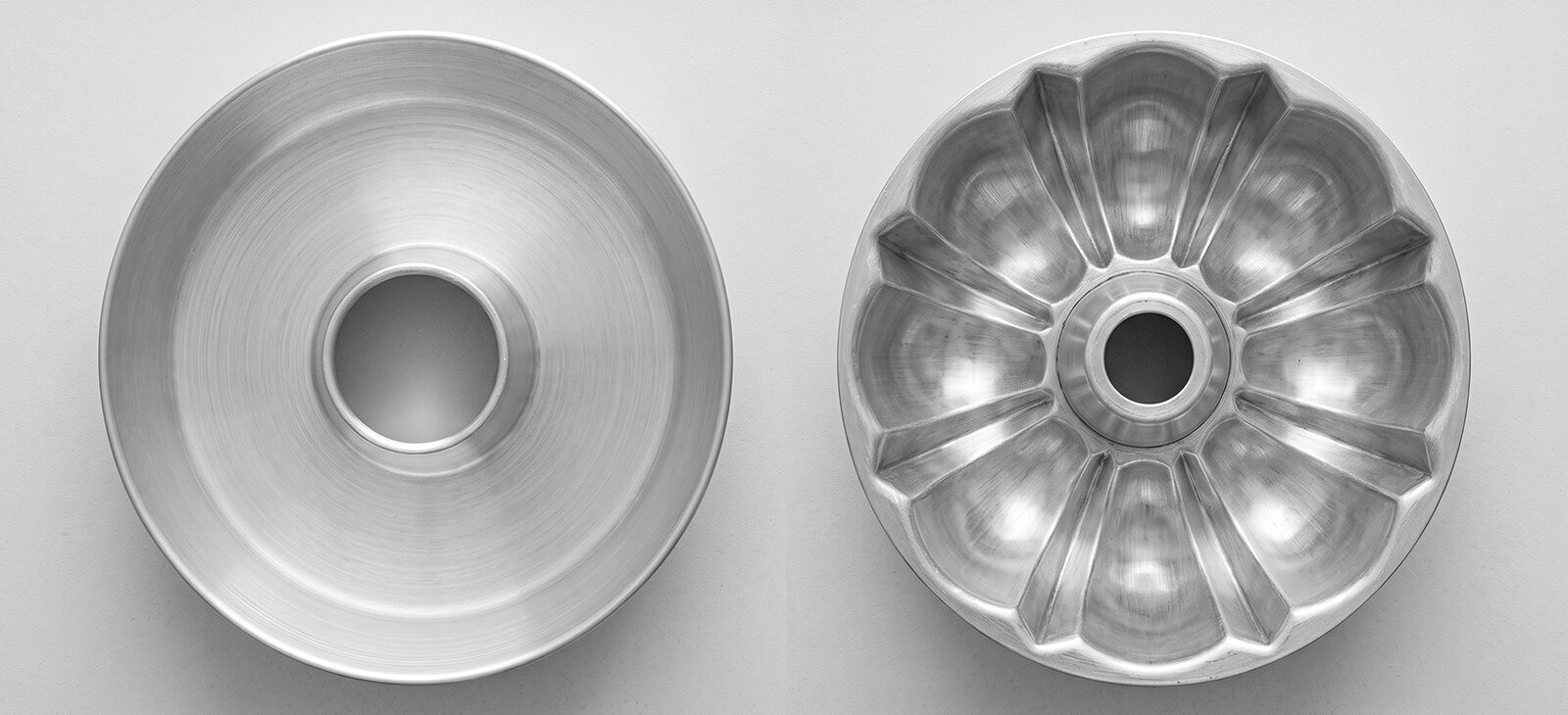Overhead comparison of a smooth-sided ring cake pan and a fluted Bundt pan